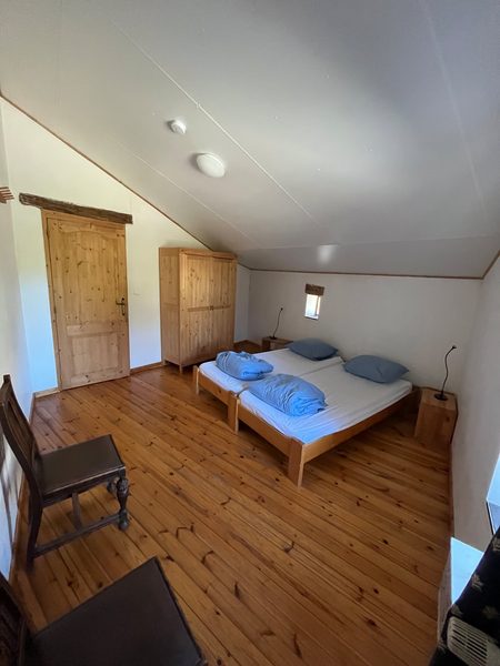 Een slaapkamer met bed onder het schuine dak.